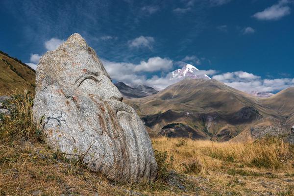 Sno Village Gigantic Stone Sculpture on Kazbek Mount Background