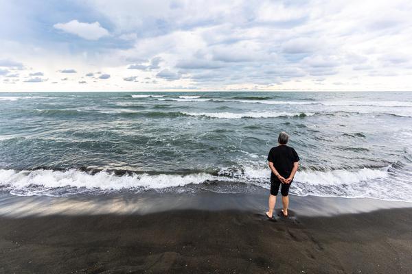 Woman Contemplating Sea at Ureki Black Sand Beach