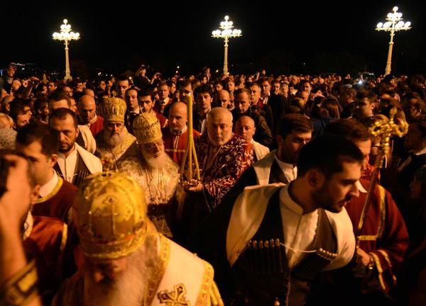 Orthodox Easter procession at Trinity Cathedral in Tbilisi, led by clergy in golden vestments