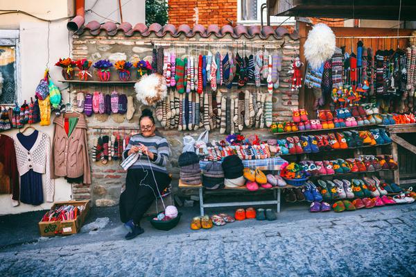 Sighnaghi vendor sells and knits woollen slippers and socks