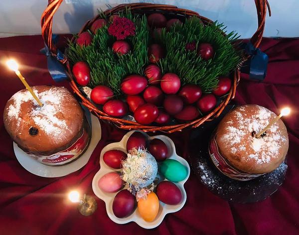 Traditional Georgian Easter table with red-dyed eggs, Paska bread, and lit candles