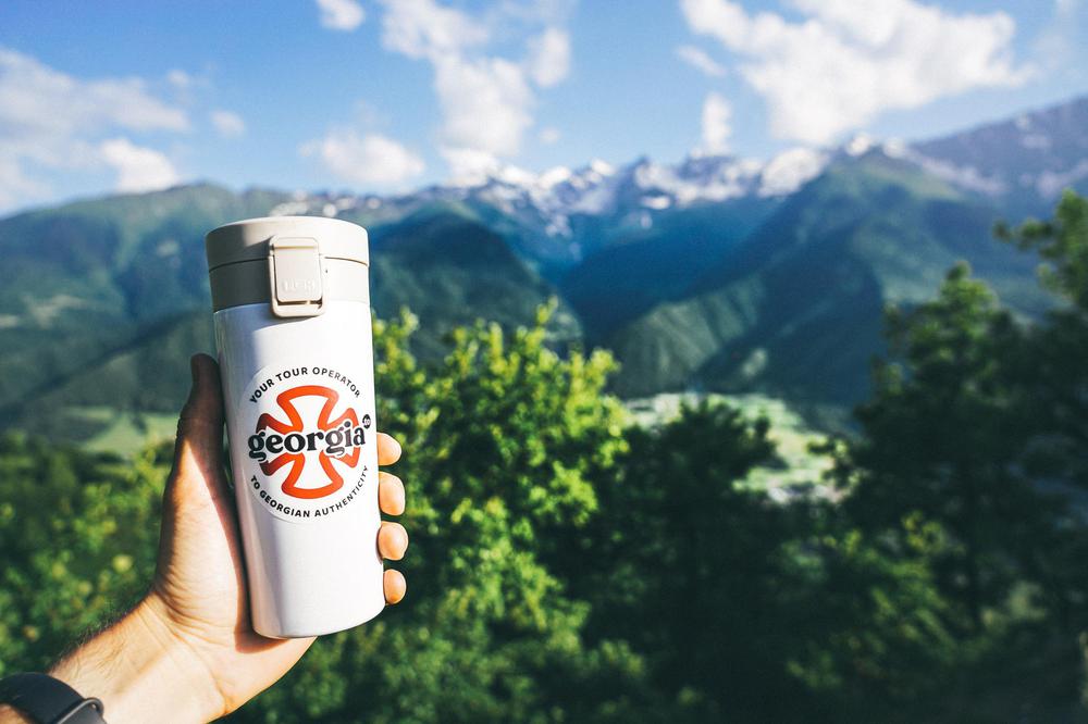 Georgia.to Mug in Front of Caucasus Mountains in Svaneti