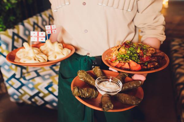 Waiter Serving Georgian Traditional Meals