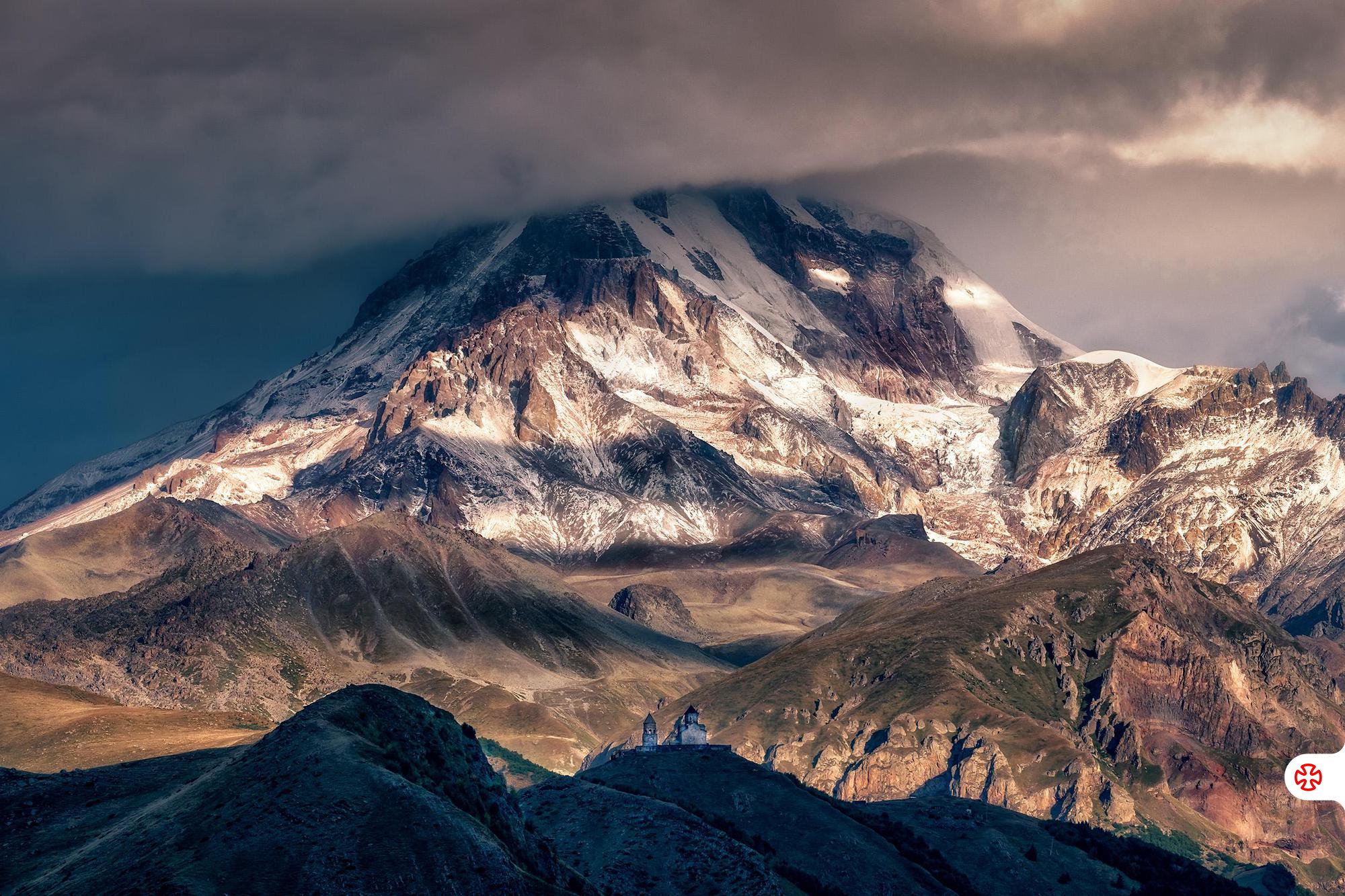 Summit of Mount Kazbek with Gergeti Trinity Church Behind